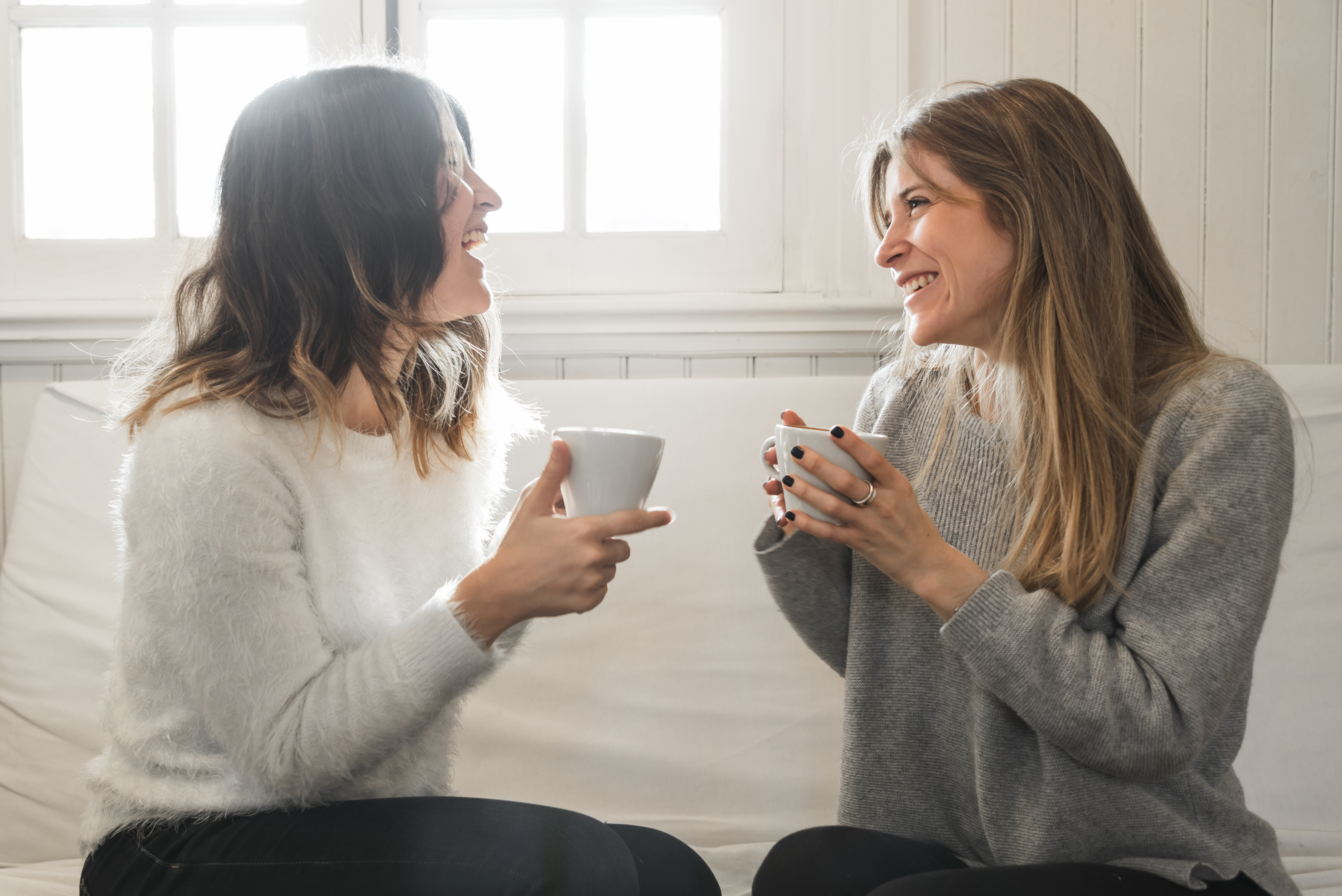 Two female friends chatting over a coffee