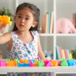 Fostering in Nottingham - Little girl plays with building blocks