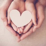 Fostering in nottingham - parent and child hands holding heart